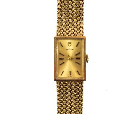 A 9ct gold Tudor ladies manual wind bracelet wristwatch. London 1974, the 14mm gilt dial with baton markers, signed 15 jewel 