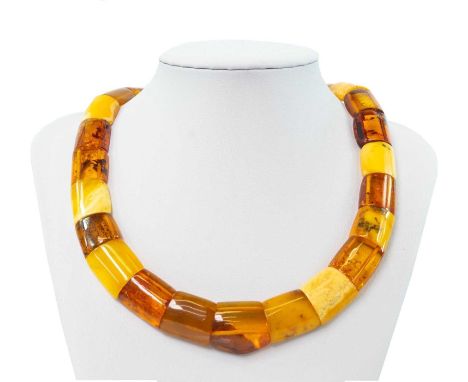 A contemporary multi-coloured amber panel bead necklace with gold plated button clasp. 40.8g.We believe this to be amber. It 