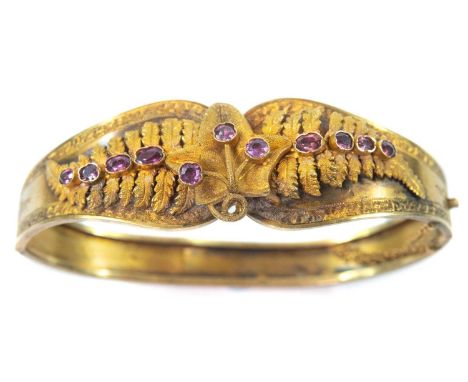 Possibly Australian, the applied fern leaves set with pink stones, the bangle with engraved bands, width 63mm, 13.25g.The bac