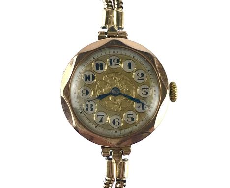 A 9ct gold cased manual wind ladies wristwatch. London 1923, on a rolled gold strap.