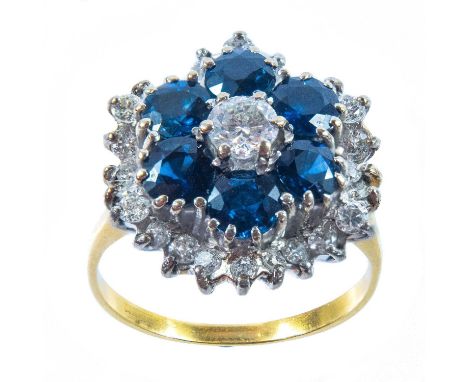 18ct gold set, the central diamond measuring 0.25ct, surrounded by six circular cut blue sapphires each 0.20ct, the outer und
