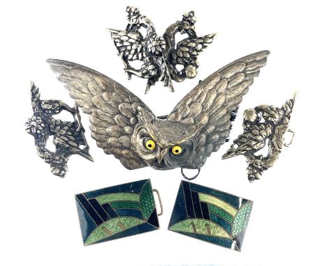 A collection of belt buckles, including a silver plated owl buckle with glass inset eyes. Together with two pairs of white me