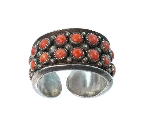 A Navaho silver coral set ring, maker T. and stamped STERLING, size X, 16.2g.