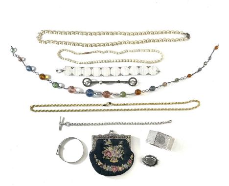 A collection of costume jewellery, including silver. Comprising a silver engine turned panel bracelet, a silver napkin ring, 