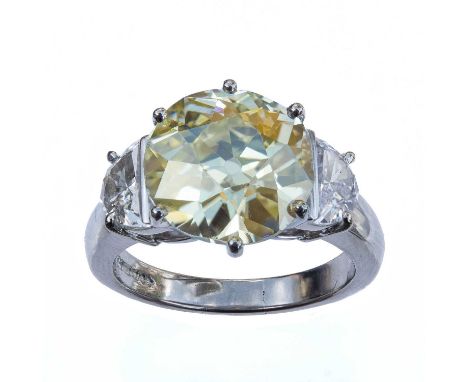 An impressive diamond solitaire ring, set in 18ct white gold, the old European cut natural fancy light yellow diamond weighin