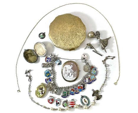 A collection of costume jewellery. To include a silver charm bracelet and six loose charms, a gold mounted carved shell cameo