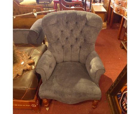A pair of Victorian style spoon back armchair with blue velour button back upholstery raised on turned legs and castors