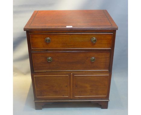 A 19th Century mahogany side cabinet with two drawers over two cupboard doors having ebony inlay raised on carved bracket fee