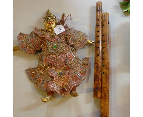 Two Chinese Bamboo flutes together with a puppet