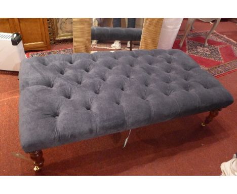 A Victorian style stool with blue velour button down upholstery raised on turned legs and castors, H:33cm W:122cm D:63cm 