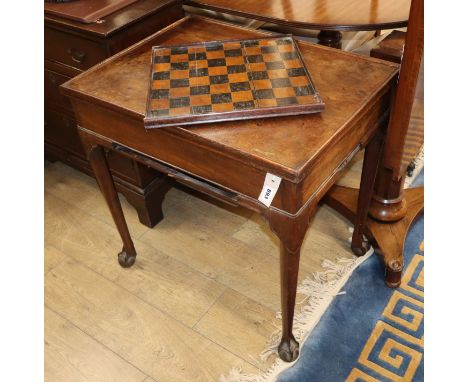 A George II mahogany backgammon table having reversible baize-lined top with counter wells and pull-out chess board W.73cm