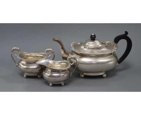 An Edwardian three-piece silver tea service, London shape with shell and gadroon borders on ball feet, Birmingham 1909, maker