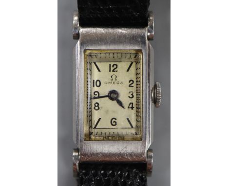 A lady's stainless steel Omega manual wind rectangular cased wrist watch, on later associated strap.