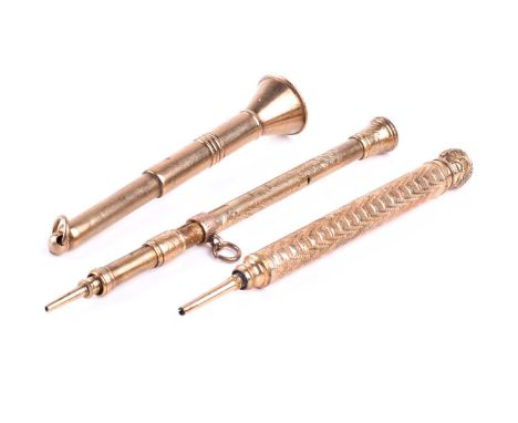 A yellow metal cigar puncher, 7.4 cm, together with two gilt metal propelling pencils, longest 10.2 cm long. (3)