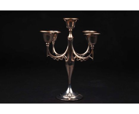 A 20th century silver candlestick, date and maker's mark rubbed, with four swept arms and central sconce, on a circular foot 