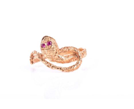 A mid to late 20th century yellow metal snake ring, set with small ruby eyes, indistinct marks to shank, possibly Egyptian, s