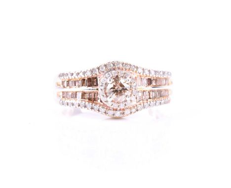 A silver and diamond dress ring, set with a light brown diamond of approximately 0.25 carats, within a border of white diamon