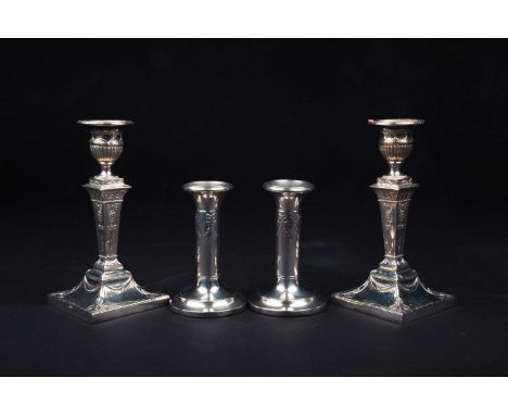 Two pairs of filled silver candlesticks, the tallest 17.5 cm high, London 1897 by Thomas Bradbury and Sons, the other pair Bi