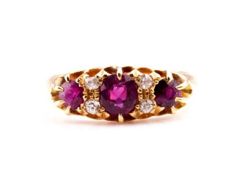 A yellow metal, diamond, and ruby ring, set with three mixed round-cut rubies and four small diamond accents, shank unmarked,