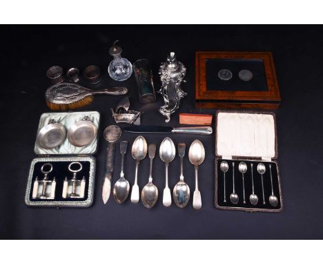 A mixed collection of silver and white metal items to include flatware, napkin rings, a Christofle page turner, a model ship,