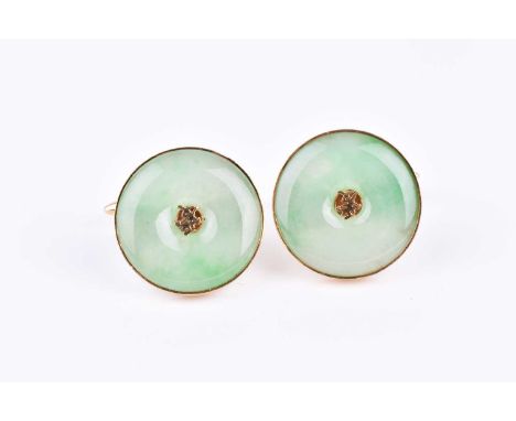 A pair of yellow metal and green jade cufflinks, of circular form, each formed with a bezel set piece of jade, inset to cente