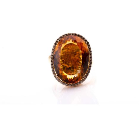 A 14ct yellow gold, diamond, and citrine cocktail ring, set with a large mixed oval-cut citrine measuring approximately 21 x 