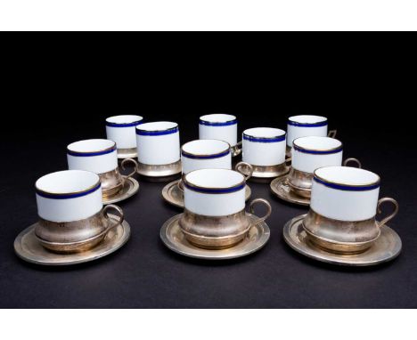 Eleven Italian porcelain and silver mounted coffee cans, together with six conforming silver saucers, 800 standard, 2.8 ozt. 