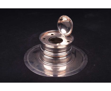 An Edwardian Scottish silver inkwell, Edinburgh 1906 by Hamilton &amp; Inches, of turned circular form on a wide base (lackin