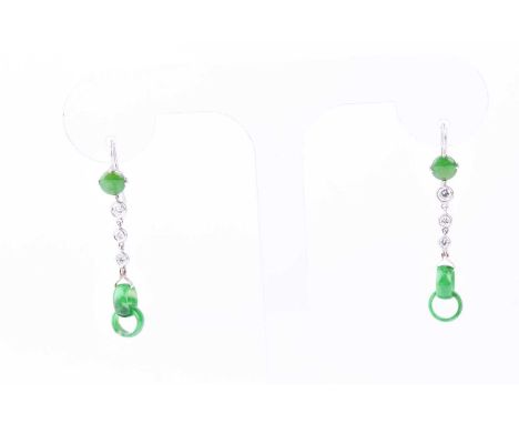 A pair of jade and diamond pendant earrings, a central circular jade cabochon suspending three graduated round brilliant cut 