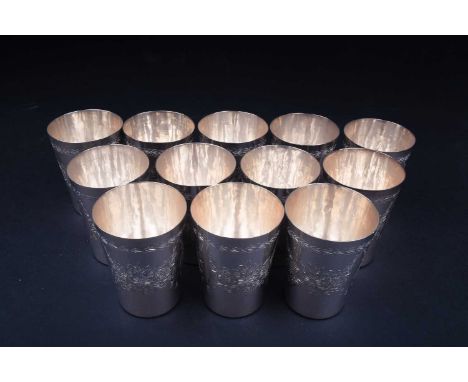 A set of twelve Continental silver beakers, each stamped 'Silver', with engraved floral decoration, 9.3 cm high, 32 ozt. comb