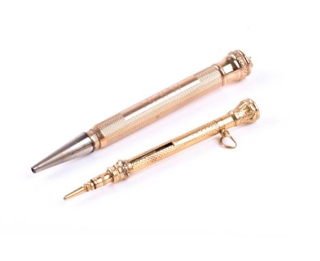A yellow metal propelling pencil, with engine-turned decoration, inset with a small amethyst, unmarked, 5.9 cm long, together