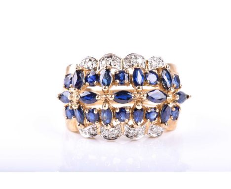 A sapphire and diamond cluster ring, the circular cut and marquise-shaped sapphires within a border of brilliant cut diamonds