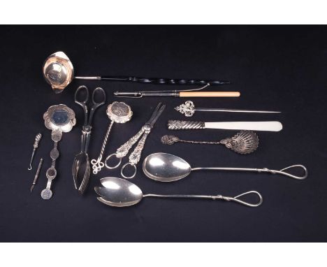 A mixed group of silver and white metal items, to include a William IV silver toddy ladle, coin inset, salad servers, grape s