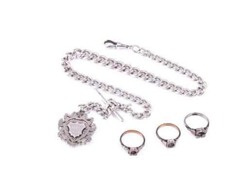 A late 19th / early 20th century silver watch chain, with gilt metal fob, 65 grams, together with three white metal ring shan