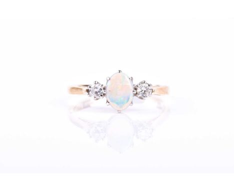 An 18ct yellow gold, diamond, and opal ring, set with an oval opal, and two round brilliant-cut diamonds of approximately 0.2