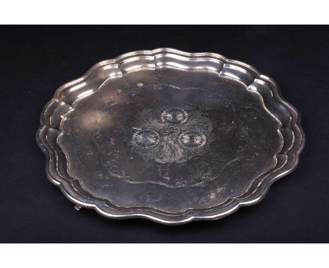 A George VI silver salver, Birmingham 1937 (maker indistinct), of scalloped edge form with engraved floral decoration on thre