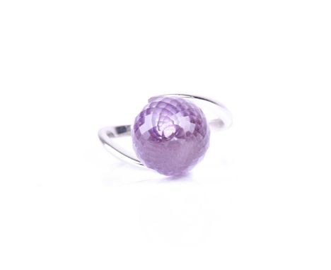 An amethyst dress ring, the multi-faceted spherical amethyst in plain polished cross-over mount marked '585'; size Q1/2, weig