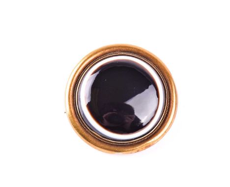 Of Royal interest. A mid Victorian gold and banded agate brooch gifted by Queen Victoria. The circular brooch set with a band