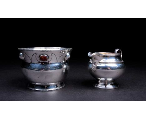 A 20th century silver bowl in the Arts &amp; Crafts style, marks rubbed, the border set with agate cabochon stones, hammered 