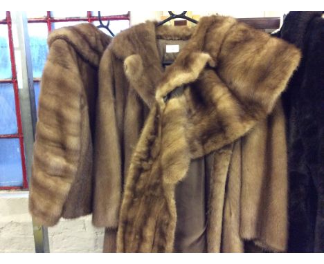 Two light brown fur jackets with shawl.