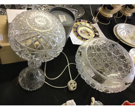 A cut glass lamp and and ceiling light with hanging chains.