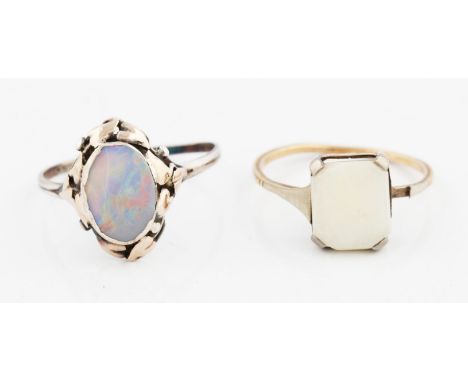 Two opal set rings, one in yellow metal, ring size M, the other in white metal, ring size P (band not round), (2).