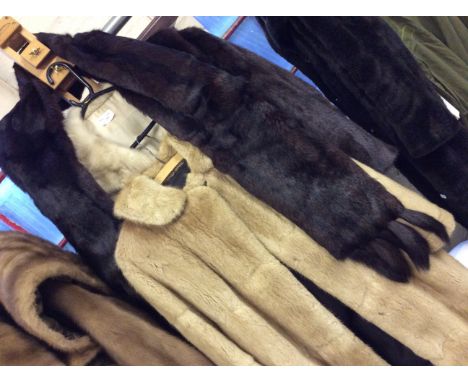 Three fur jackets short short and one long with dark brown fur scarf.