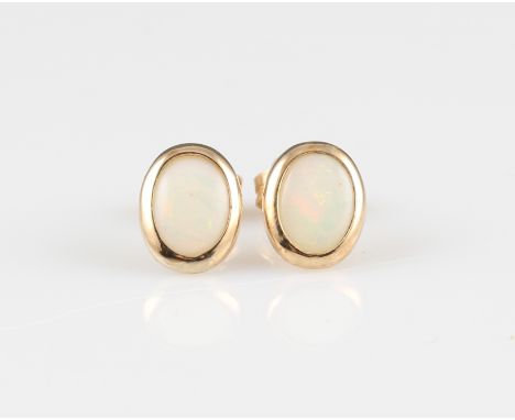 A pair of opal stud earrings, each bezel set with an oval opal cabochon, stamped 9ct 375, weight approx. 1.1g.