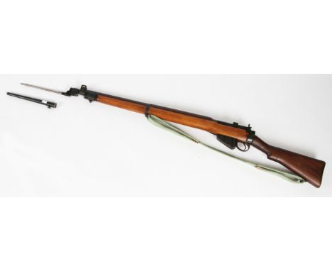 A WW2 Lee Enfield .303 No.4 Mk I rifle, dated 1944 and numbered to side 10940, together with spike bayonet and scabbard, with