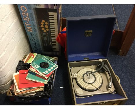 A Casiotone MT-520 and a Dansette record player with various records.