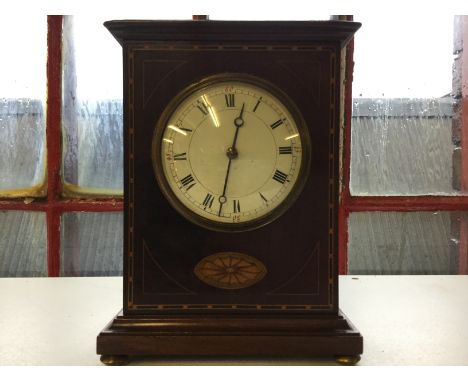 An Edwardian mahogany mantel clock with inlay decoration.