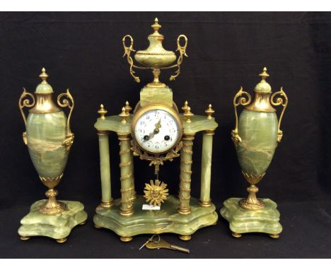 A late 19th Century green onyx and gilt finish clock garniture, clock having column supports with swag and foliage design wit