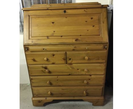 A modern pine 5 drawer bureau with pull out tray. Wired in light and brown leather insert to interior. Approx. 86½ x 111cm ta