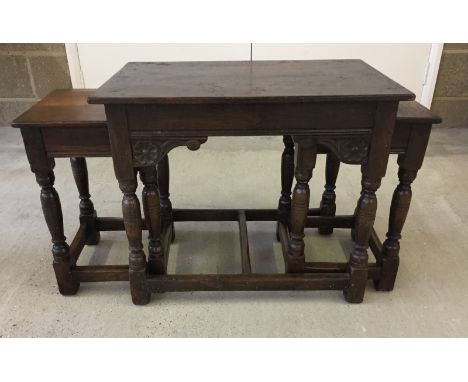 A nest of 3 oak 'Old Charm' style coffee tables. Made by G.T. Rackstraw Ltd, Worcester. One measures 61 x 38cm and 51cm tall,